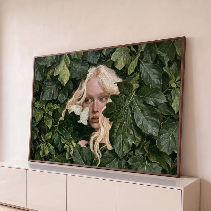 Mulher loira de sardas espiando entre folhagem verde com borboleta branca no rosto, quadro decorativo