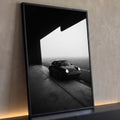 Quadro Decorativo Grande Carro Clássico Preto para Sala | quadros decorativos para sala | carro esportivo clássico preto estacionado na saída de um hangar com neblina ao fundo | Porao dos Quadros