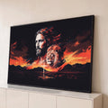 Rosto de Jesus ao lado de leão, cruz e montanhas sob céu laranja em fundo preto, quadro decorativo