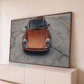 Quadro Decorativo Grande Carro Laranja Metálico para Sala | quadros decorativos para sala | carro esportivo laranja metálico fotografado de frente sobre piso de concreto | Porao dos Quadros