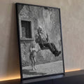 Avô sorrindo em balanço de corda e neta junto a parede de pedra antiga em preto e branco, quadro decorativo