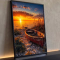 Barco de madeira vermelho em praia de pedras com capim e pôr do sol laranja sobre o mar, quadro decorativo
