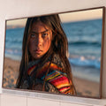 Quadro Decorativo Grande Menina com Poncho para Sala Azul | quadros decorativos para sala | menina de cabelos escuros com poncho colorido à beira-mar ao pôr do sol | Porao dos Quadros