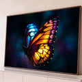 Quadro Decorativo Grande Borboleta com Asas para Sala | quadros decorativos para sala | borboleta com asa laranja e roxa de um lado e asa azul turquesa do outro, fundo escuro | Porao dos Quadros