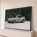 Porsche 911 clássico verde sage com rodas Fuchs em pátio de pedras e muro de hera, quadro decorativo