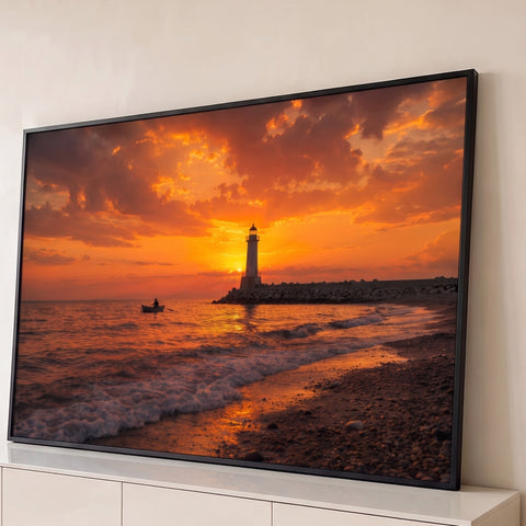 Farol ao pôr do sol com remador em barco no mar, céu laranja e praia de pedras, quadro decorativo