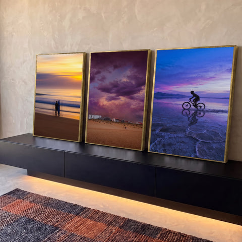 Quadro Decorativo Kit 3 Telas Praia Tempestade para Sala | quadros decorativos para sala | tríptico com surfista, nuvens roxas e ciclista cruzando água ao entardecer | Porao dos Quadros