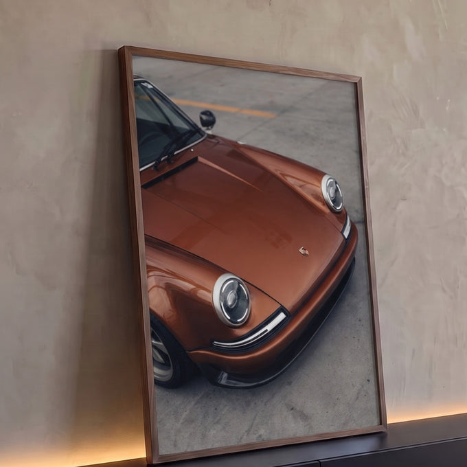 Porsche 911 clássico cobre metálico com faróis redondos sobre piso de concreto, quadro decorativo