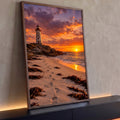 Farol branco sobre rochas, praia com pegadas e algas e pôr do sol laranja no mar, quadro decorativo