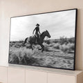 Cowgirl de chapéu cavalgando a galope no deserto, fotografia em preto e branco, quadro decorativo