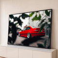 Carro esportivo vermelho rebaixado com rodas prateadas em rua entre folhas desfocadas, quadro decorativo
