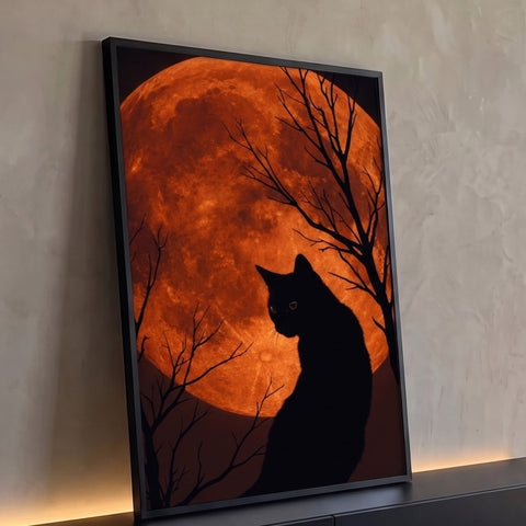 Silhueta de gato preto diante de lua cheia laranja gigante entre galhos secos, quadro decorativo