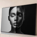 Rosto de mulher de olhos fechados dividido em metade clara e metade escura, fundo preto e branco, quadro decorativo