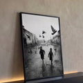 Fotografia preto e branco de dois meninos correndo entre pombos em rua antiga molhada, quadro decorativo