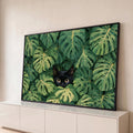 Gato preto de olhos amarelos espiando entre folhas verdes de monstera, ilustração, quadro decorativo