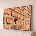 Quadro Decorativo Grande Borboleta Laranja para Sala | quadros decorativos para sala | borboleta laranja com manchas pretas pousada em parede de tijolos vermelhos | Porao dos Quadros