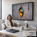 Arara azul e amarela espiando pelo oco de um tronco de madeira cinza, fotografia, quadro decorativo