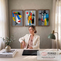 Quadro Decorativo Kit 3 Telas Rostos Cubistas para Sala | quadros decorativos | três rostos cubistas coloridos com formas geométricas e cílios espetados em preto | em ambiente 2 | Porao dos Quadros