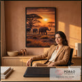 Quadro Decorativo Grande Elefantes na Savana para Sala | quadros decorativos | três elefantes caminhando na savana africana ao pôr do sol laranja | em ambiente 2 | Porao dos Quadros