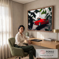 Carro esportivo vermelho rebaixado com rodas prateadas em rua entre folhas desfocadas, quadro decorativo