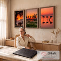 Quadro Decorativo Kit 3 Telas Pôr do Sol Elefante para Sala | quadros decorativos | tríptico com elefante, palmeiras e flamingos em silhueta sob céu laranja de pôr do sol | em ambiente 2 | Porao dos Quadros