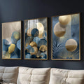 Quadro Decorativo Tríptico Elegante em Azul | quadros decorativos para sala | Três telas com folhas douradas, esferas bege e tons azuis em composição sofisticada. | Porao dos Quadros