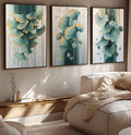 Quadro Decorativo Trio de Folhas Abstratas para Inspiração e Estilo | quadros decorativos para sala | Três telas com folhas de ginkgo biloba em aquarela verde-água e dourado sobre fundo amadeirado com respingos. | Porao dos Quadros