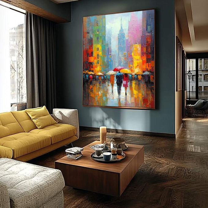 Quadro Decorativo Cidade em Movimento | quadros decorativos para sala | Cena de rua chuvosa com guarda-chuvas em cores vibrantes e edifícios de metrópole ao fundo. | Porao dos Quadros