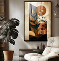 Folhagens estilizadas diante de sol laranja e blocos preto e bege em estilo boho, quadro decorativo