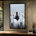 Cavalo negro em destaque no meio de uma manada de cavalos brancos sob céu claro, quadro decorativo