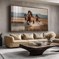 Quadro Decorativo Cavalos Galopando Livres | quadros decorativos para sala | Três cavalos selvagens em galope pela água com luz dourada ao fundo montanhoso. | Porao dos Quadros