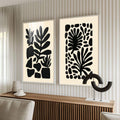 Quadro Decorativo Elegância Natural | quadros decorativos para sala | Duas telas com folhas abstratas em silhuetas pretas sobre fundo bege, composição minimalista e contemporânea. | Porao dos Quadros