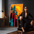 Quadro Decorativo Cidade ao Pôr do Sol Vibrante | quadros decorativos para sala | Cidade futurista com edifícios em azul e preto contra céu laranja e amarelo incandescente com figuras humanas | em Quadros para Sala | Porao dos Quadros