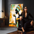 Quadro Decorativo Feminino Sereno e Vibrante | quadros decorativos para sala | Mulher africana com turbante laranja e verde em silhueta preta com brinco dourado. | em Quadros para Sala | Porao dos Quadros