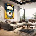 Quadro Decorativo - Frida Kahlo Energizante em Amarelo | quadros decorativos | Mulher em pop art com óculos redondos azuis, flores amarelas acima, paleta vibrante. | em Quadros para Escritorio | Porao dos Quadros