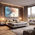 Quadro Decorativo Caminho da Serenidade | quadros decorativos premium | Mulher em branco caminhando em direção a árvore sakura rosa e bege com floresta azul ao fundo | em ambiente 4 | Porao dos Quadros