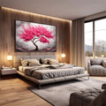 Quadro Decorativo Árvore da Esperança | quadros decorativos premium | Árvore com galhos retorcidos e flores rosa em explosão contra céu cinzento e solo árido | em ambiente 4 | Porao dos Quadros