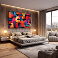 Quadro Decorativo Abstrato Vibrante | quadros decorativos premium | Composição geométrica abstrata com cúpulas e semicírculos em laranja, azul, vermelho e rosa vibrantes sobre fundo preto. | em ambiente 4 | Porao dos Quadros
