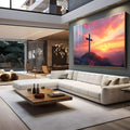 Cruz de madeira no alto de um monte rochoso com pássaros e céu rosa ao pôr do sol, quadro decorativo