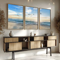 Praia com ondas, gaivotas voando e céu azul com sol baixo no horizonte, quadro decorativo