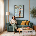 Quadro Decorativo Grande Menino com Maçã para Sala Azul | quadros decorativos para sala de estar | menino equilibrado sobre pilha de livros coloridos segurando uma maçã vermelha | em ambiente 3 | Porao dos Quadros