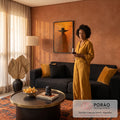 Quadro Decorativo Grande Figura com Chapéu para Sala Laranja | quadros decorativos para sala de estar | silhueta com chapéu largo e manto sobre fundo laranja com folhas pretas flutuando | em ambiente 3 | Porao dos Quadros