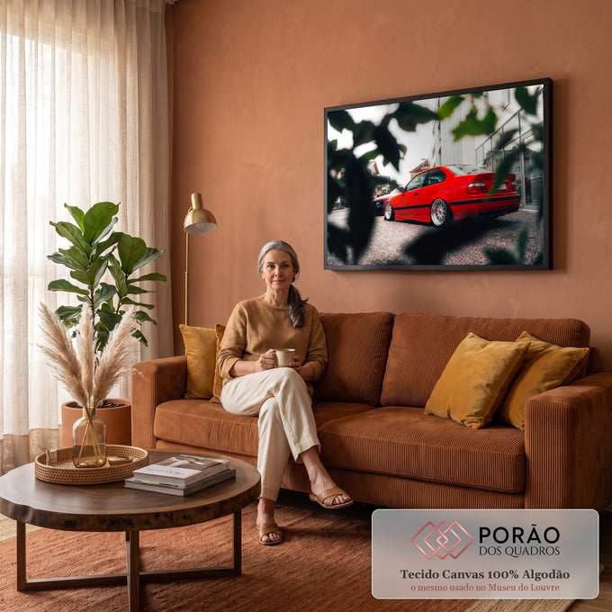 Carro esportivo vermelho rebaixado com rodas prateadas em rua entre folhas desfocadas, quadro decorativo