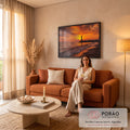 Quadro Decorativo Grande Farol ao Pôr do Sol Mar para Sala | quadros decorativos para sala de estar | farol branco contra céu laranja intenso com barco solitário e praia de pedras | em ambiente 3 | Porao dos Quadros