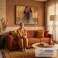 Quadro Decorativo Grande Três Indígenas para Sala Laranja | quadros decorativos para sala de estar | três indígenas a cavalo de costas em cena dourada com manto laranja geométrico | em ambiente 3 | Porao dos Quadros