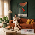 Mulher de vestido laranja e botas amarelas em balanço sob balão de rede, fundo verde, quadro decorativo